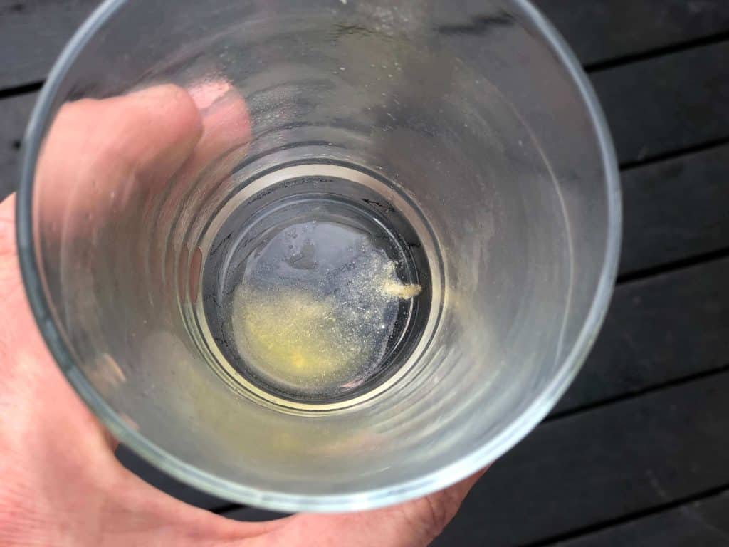 Undissolved Advocare Spark powder in a glass