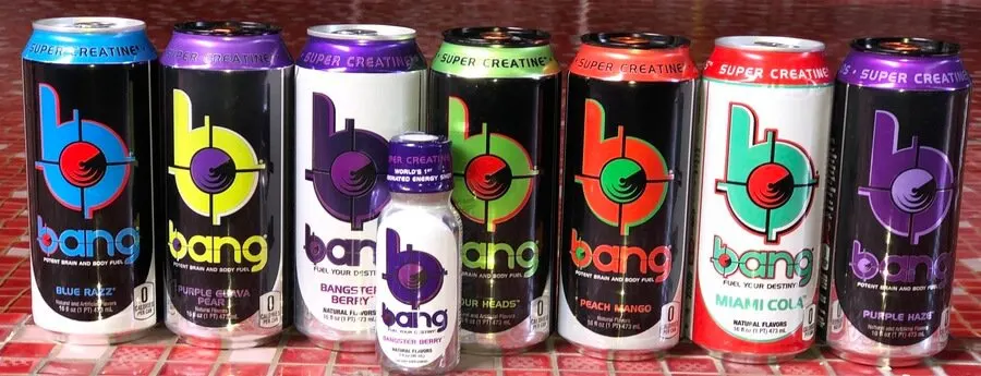 Some of the flavors of Bang energy drink pictured together with a Bang shot.