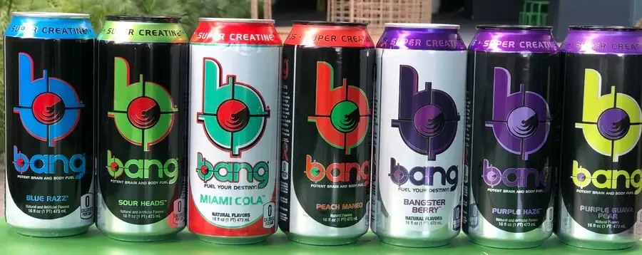 A series of Bang cans lined up side by side on a table.