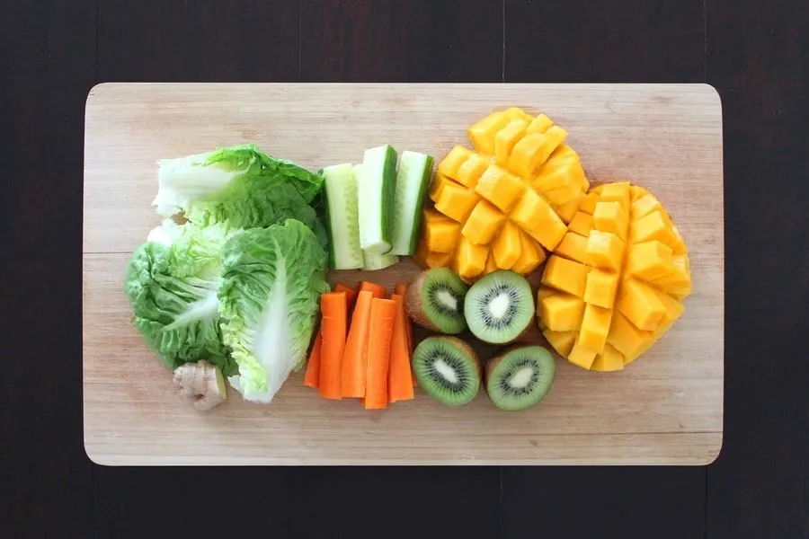 vegetables and fruits on a wooden chopping board
