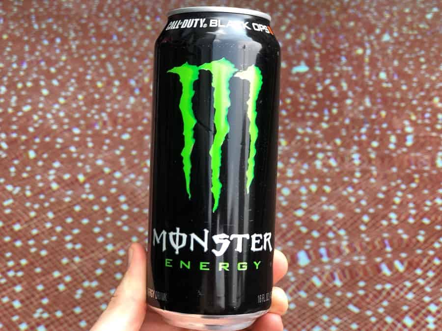 A can of Monster Energy Drink held in someone's hand. 
