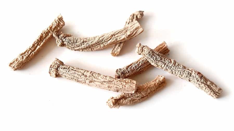 Pieces of dried ginseng on a white background.

