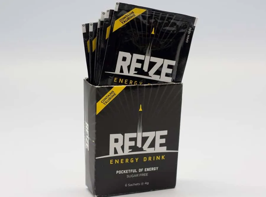 Packets of REIZE energy drink sticking out of the box.