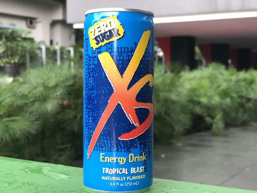 XS Energy drink on a green table.