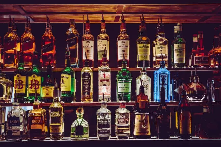 Shelf full of various liquor and spirits.