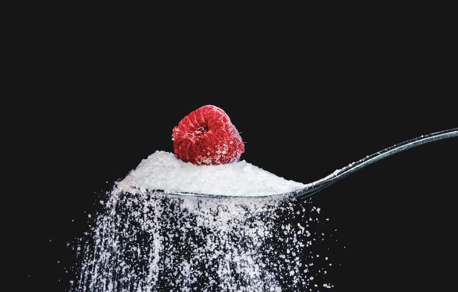 a tablespoon of sugar with a raspberry in it