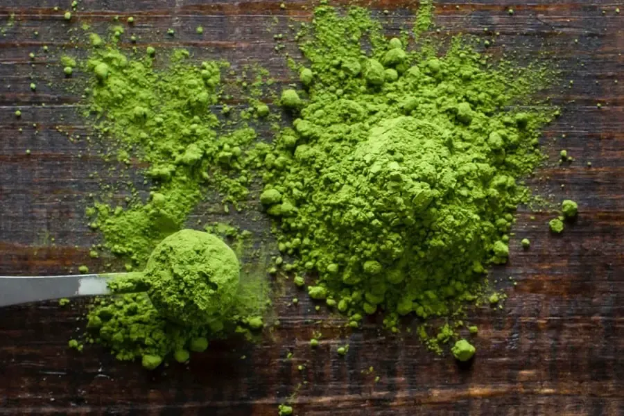 Green tea powder on a wooden table.