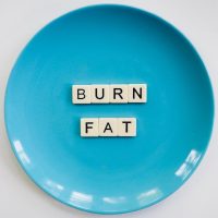 A plate with Burn Fat spelt out in tile blocks