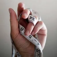 A picture of a hand holding measuring tape