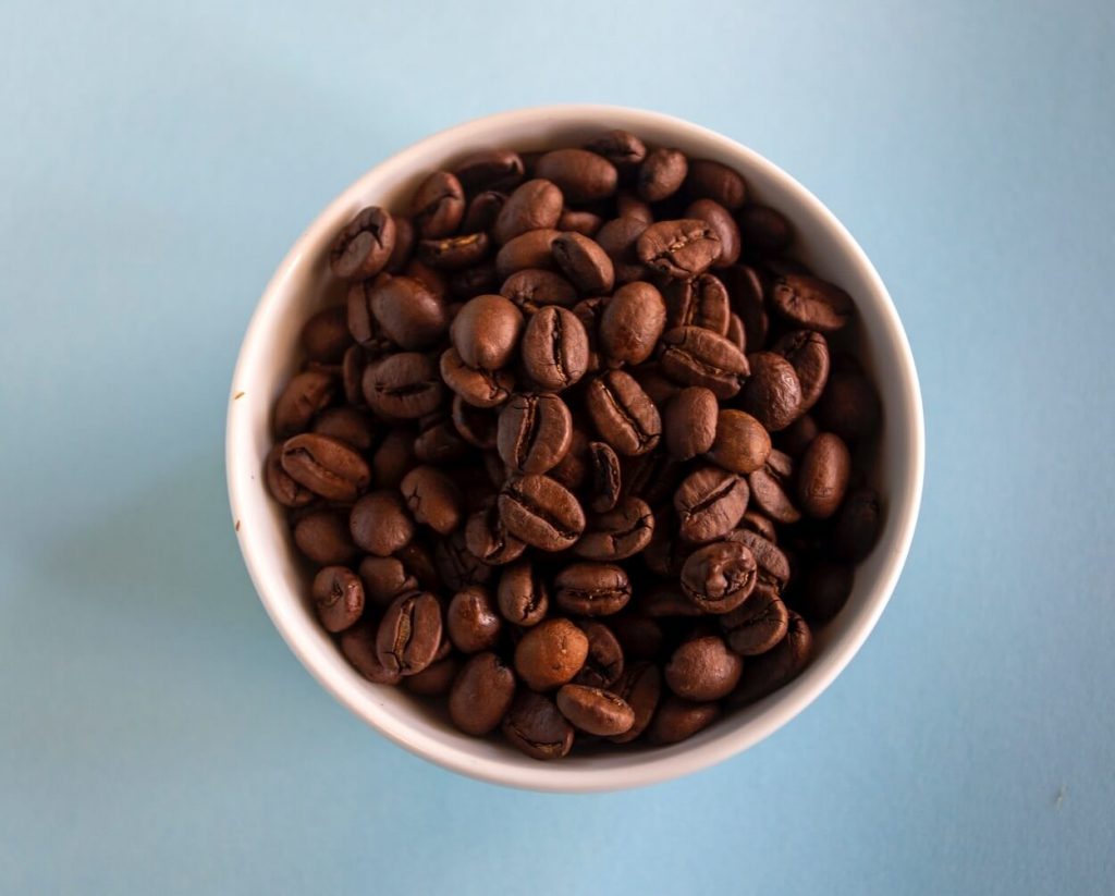A view of a cup of coffee beans from above. 