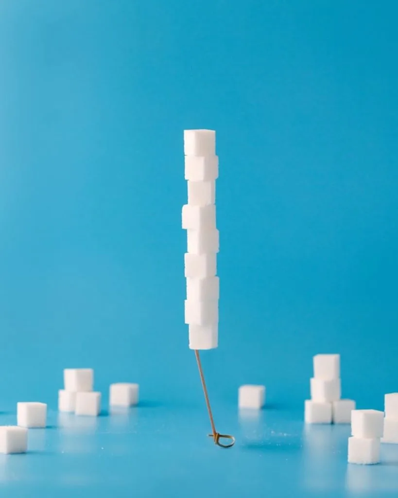 Cubes of sugar stacked on a wooden stick.