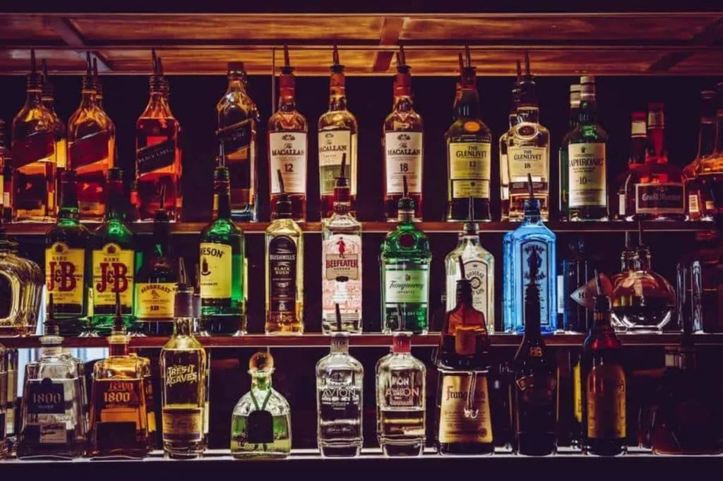 Alcohols stacked in a bar.