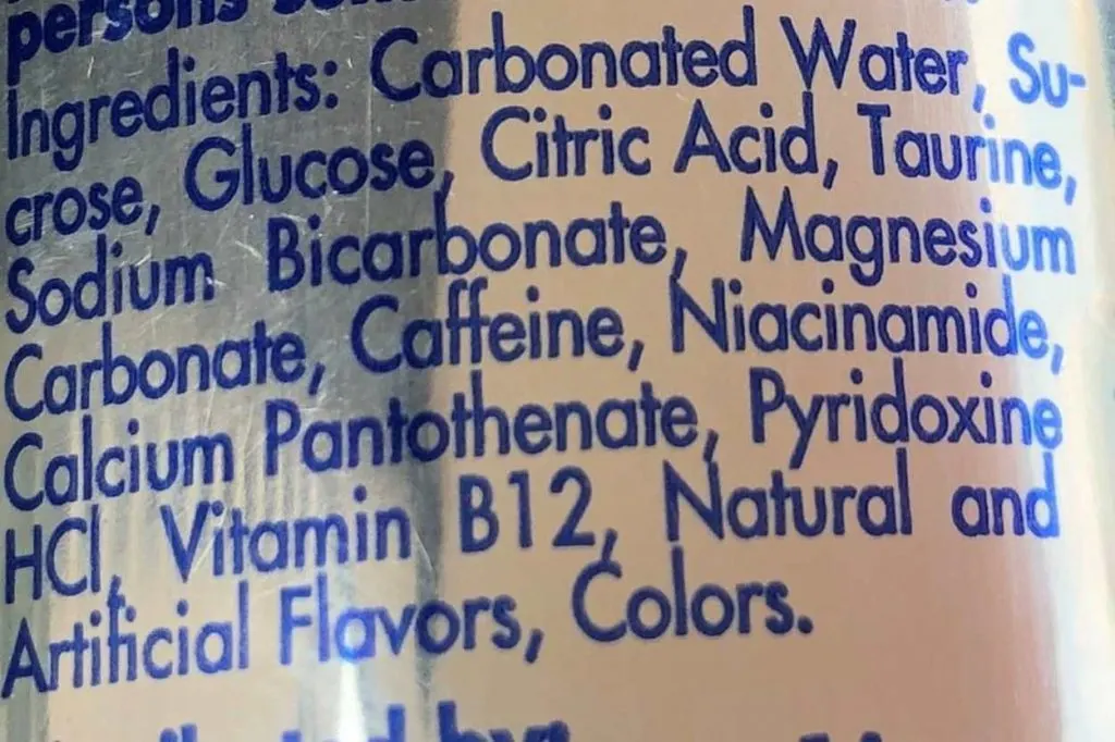 A close up on the ingredients list of Red Bull. 