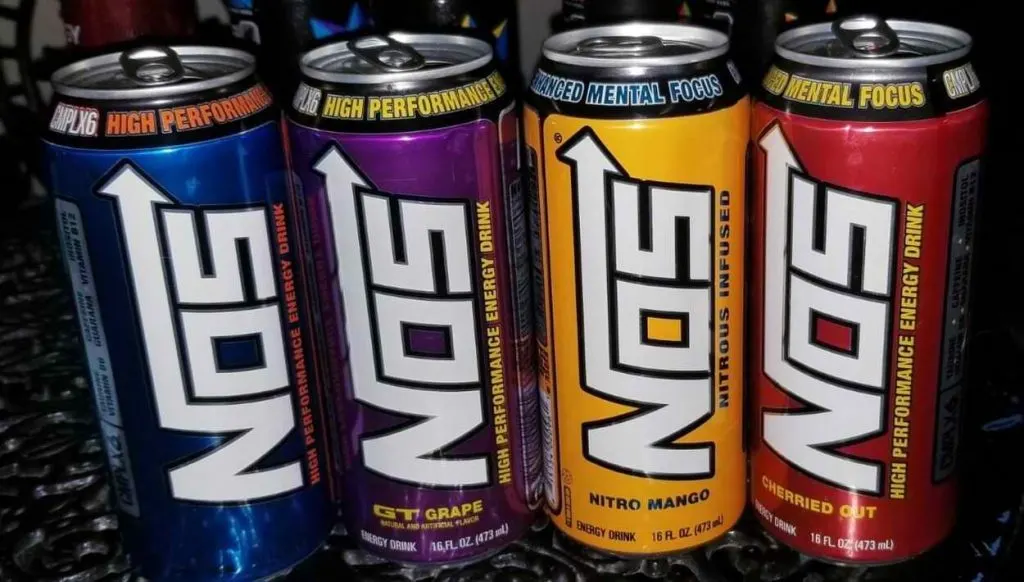 4 cans of NOS energy drink of different colors.