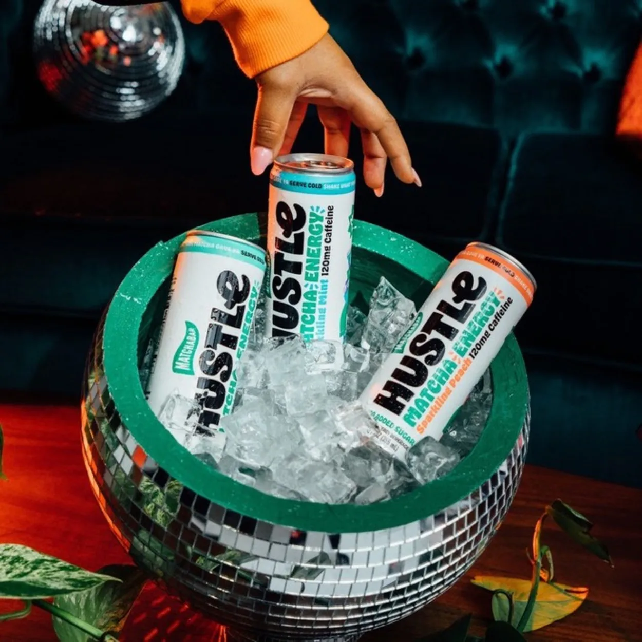 Three cans of MatchaBar Hustle in a bucket of ice. 