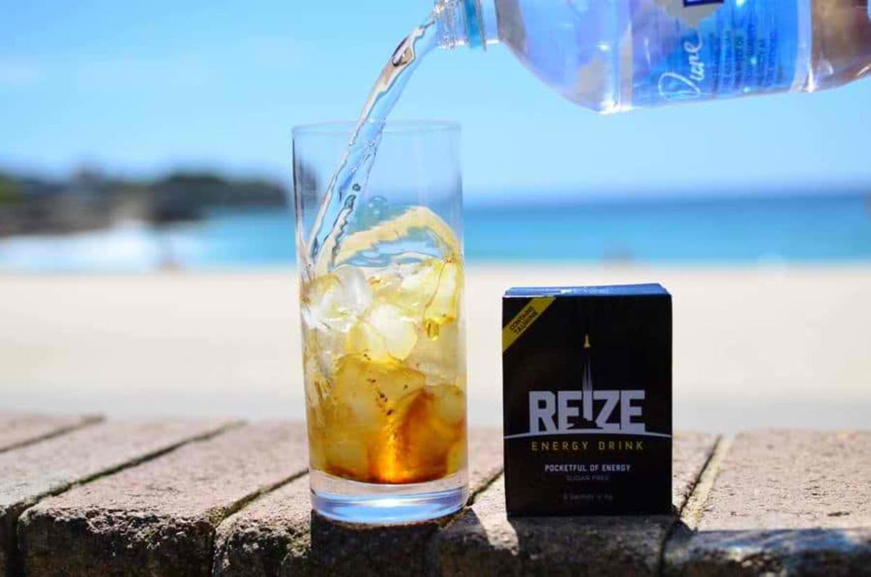 A glass of REIZE energy drink.