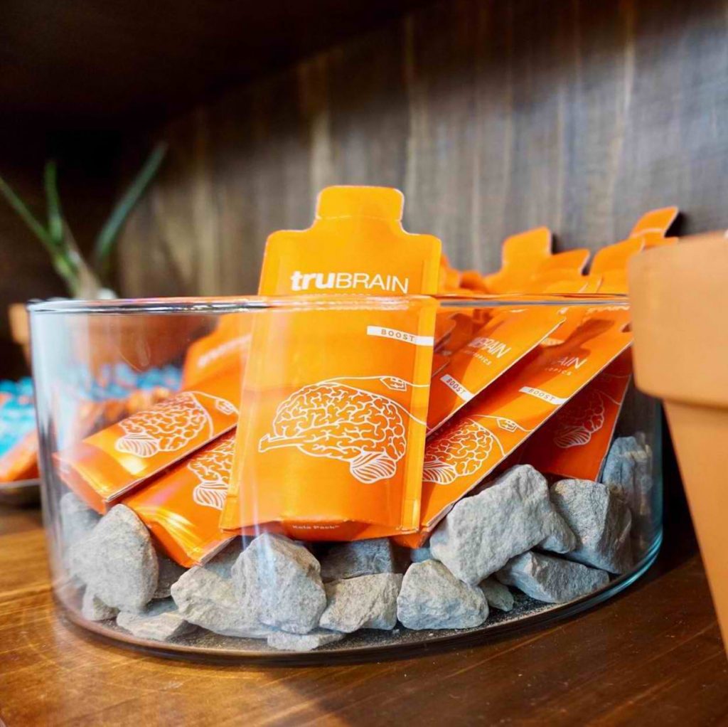 Sachets of TruBrain in a glass container. 
