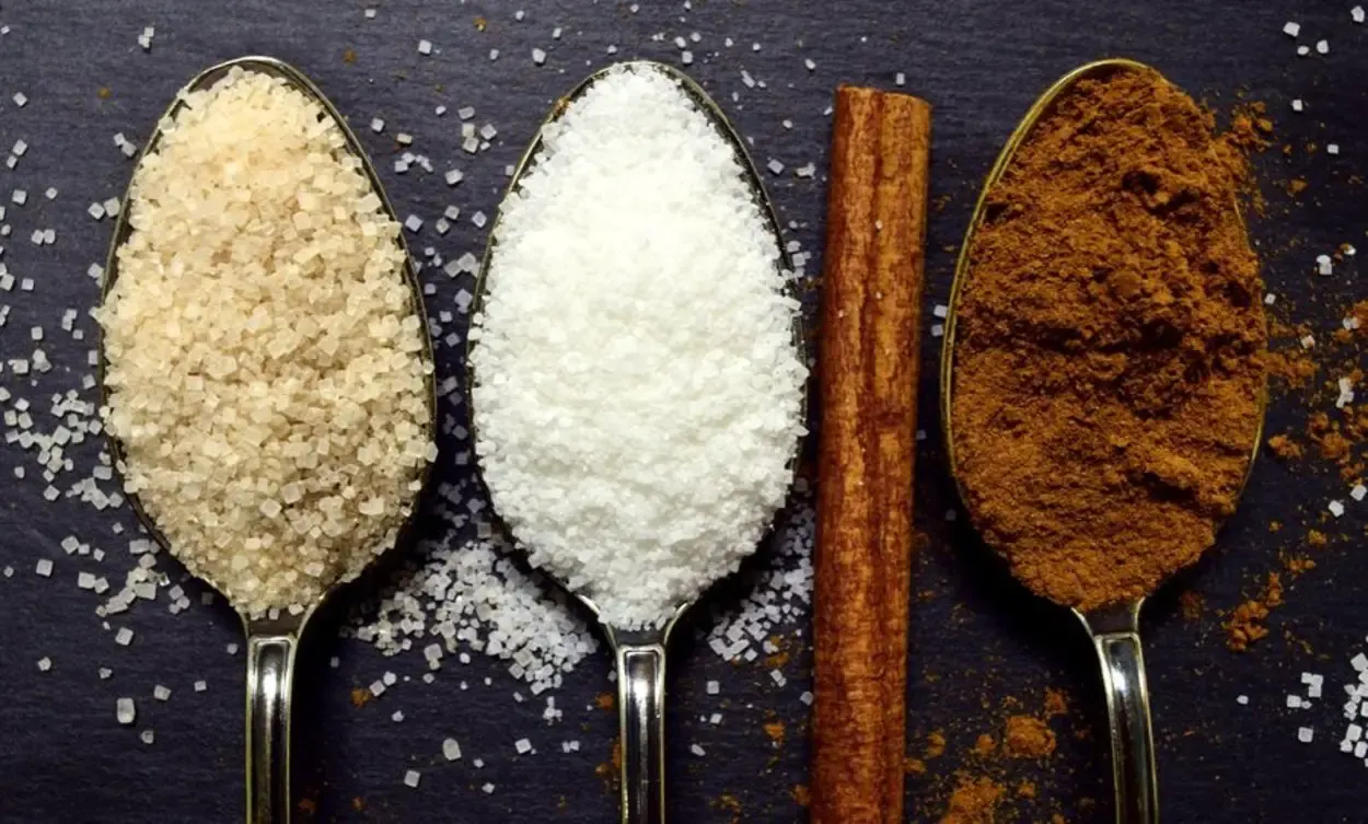 3 spoons of different types of sugar.