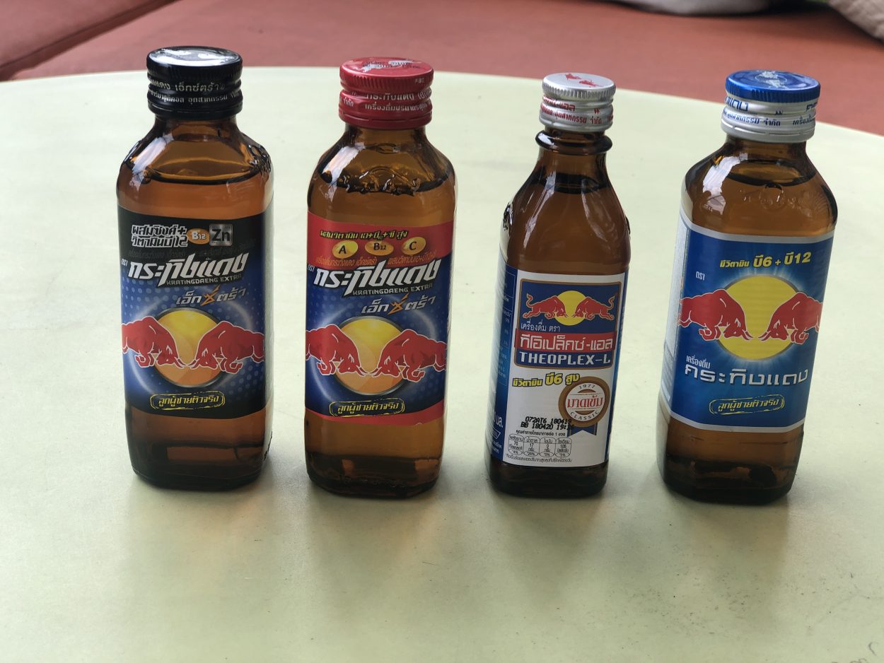 Four small bottles of apparently different versions of Krating Daeng.