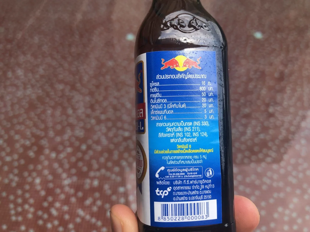 Nutritional facts printed with Thai script on the side of a bottle of Krating Daeng.