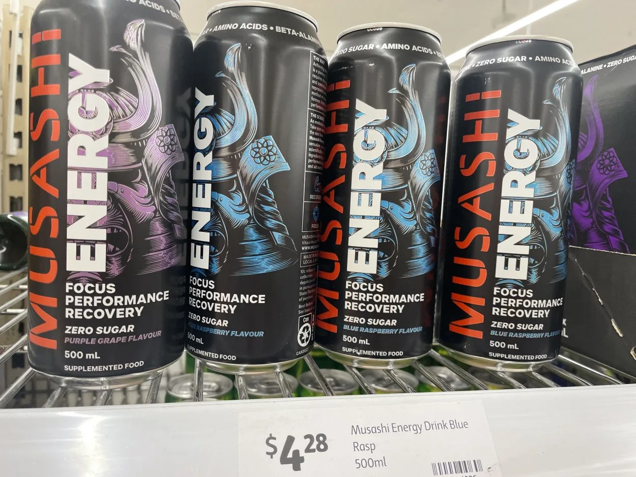Four cans of Musashi energy drink. Three blue raspberry flavour and one purple grape flavour.