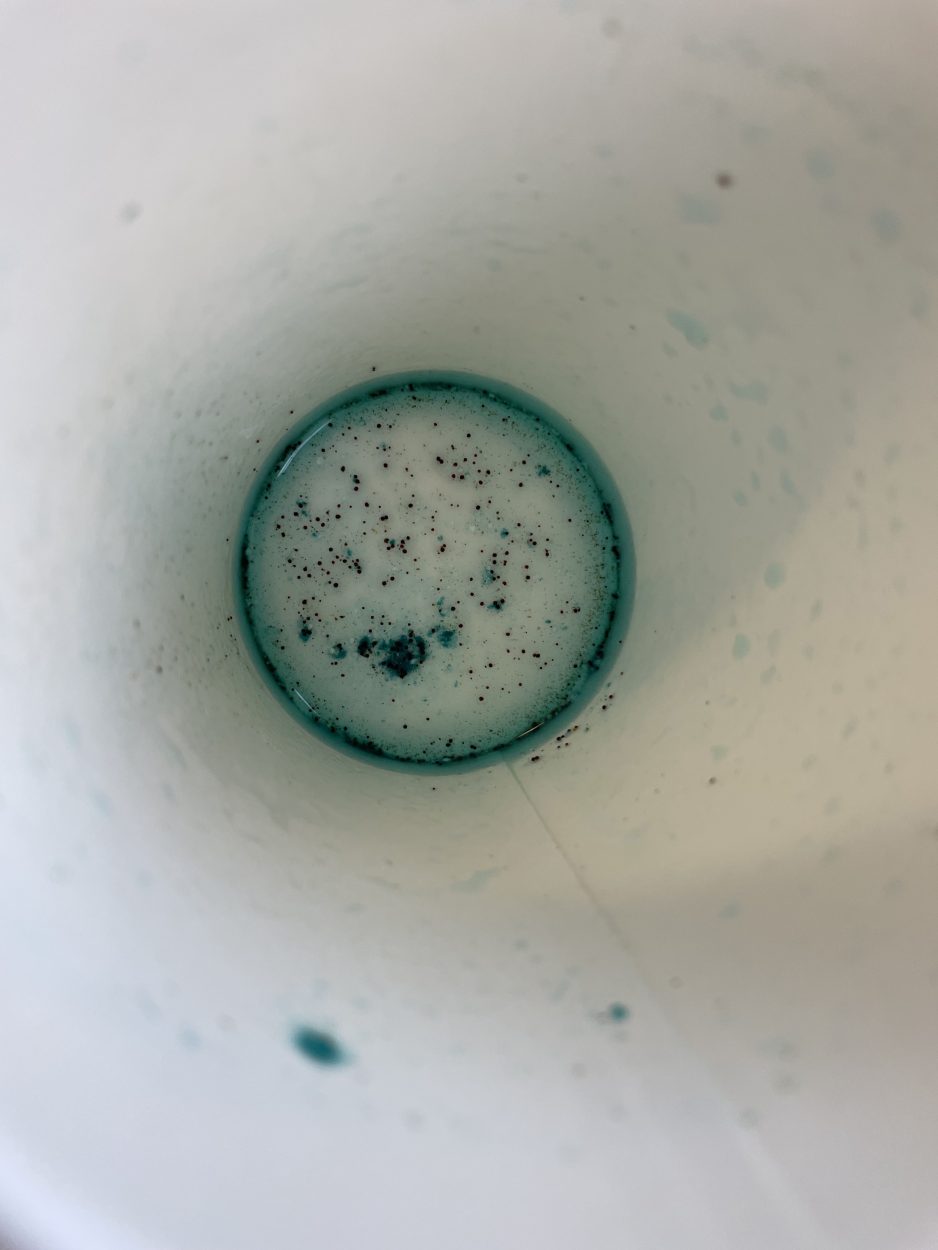 Powdered residue at the bottom of a cup.