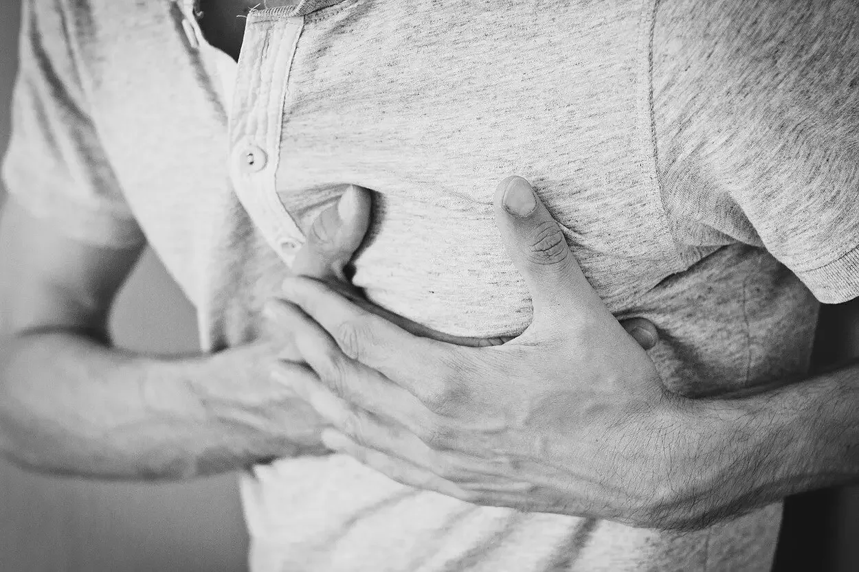 A person holding his chest in pain.