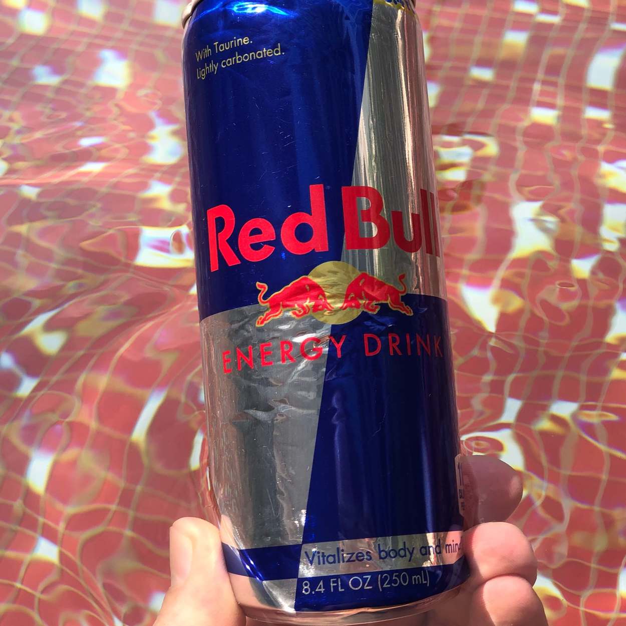 An 8.4 fluid ounce can of Red Bull energy drink